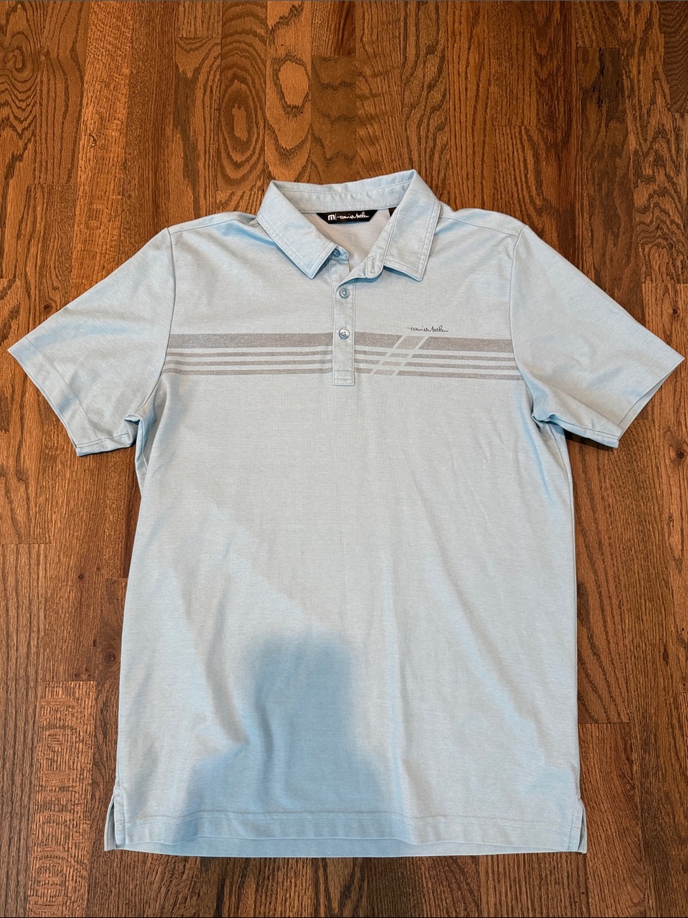 Travis Mathew Men's Light Blue Polo Shirt with Subtle Stripe Detail | Size M